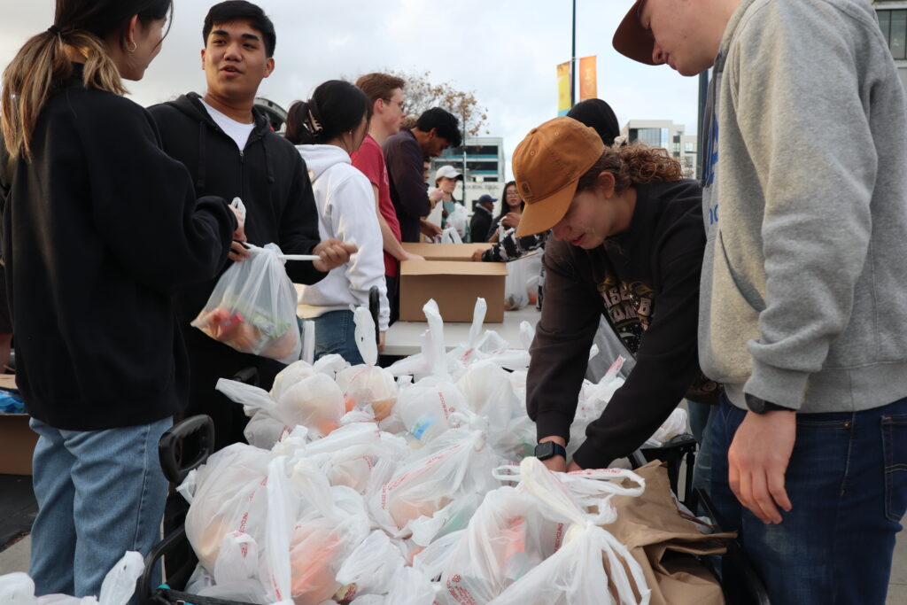 Streets of Hope volunteers assemble bags of food and pack them into wagons for distribution.