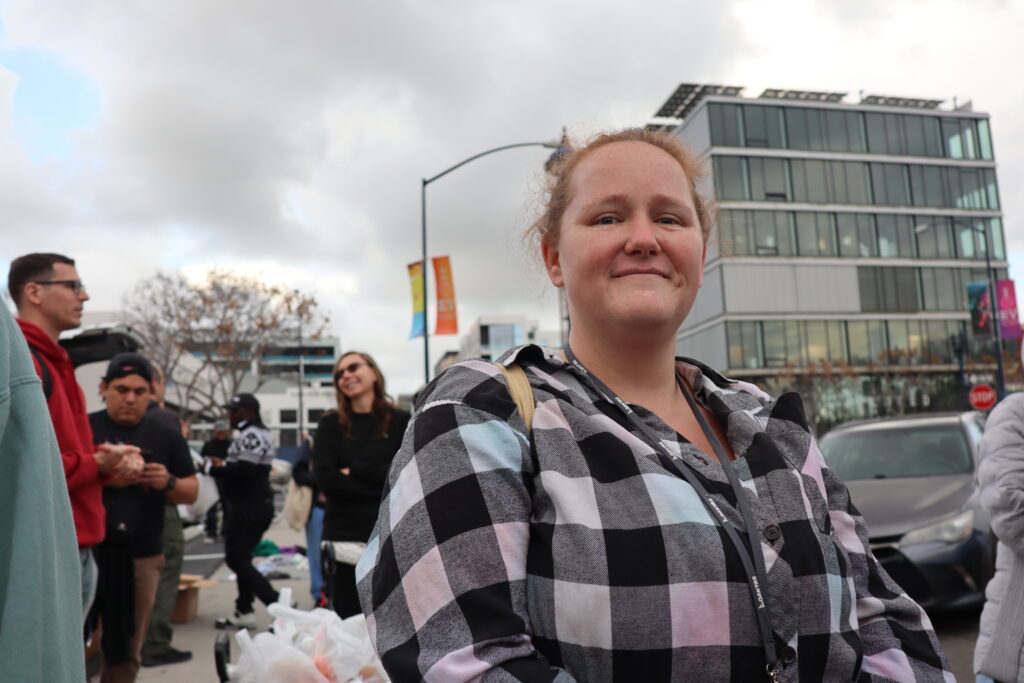 A woman named Debra Near poses for a photo in downtown San Diego before passing out supplies to the homeless community.